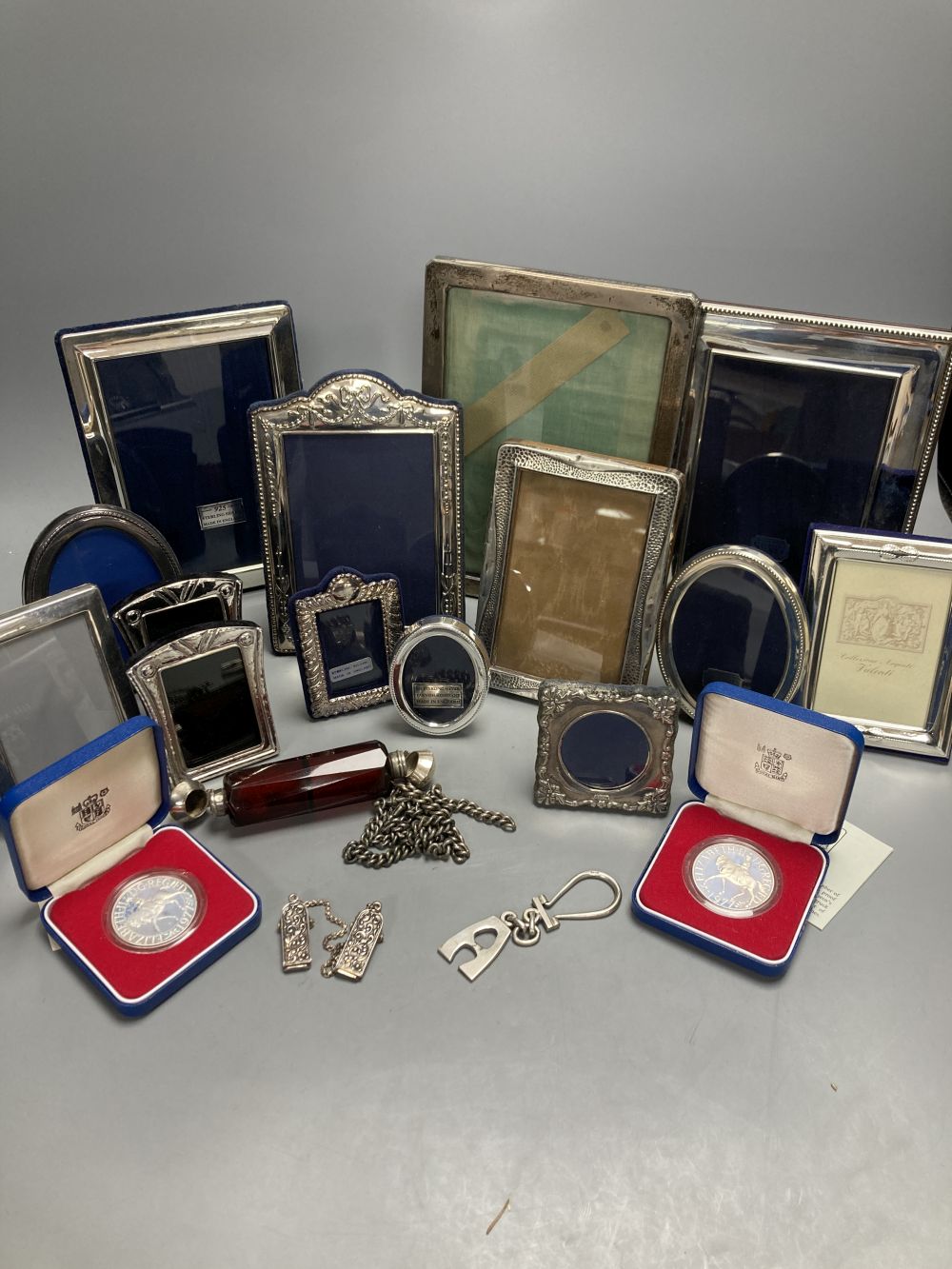 Two George V silver mounted photograph frames, largest 21cm, nine other modern silver frames and two cased silver crowns etc.